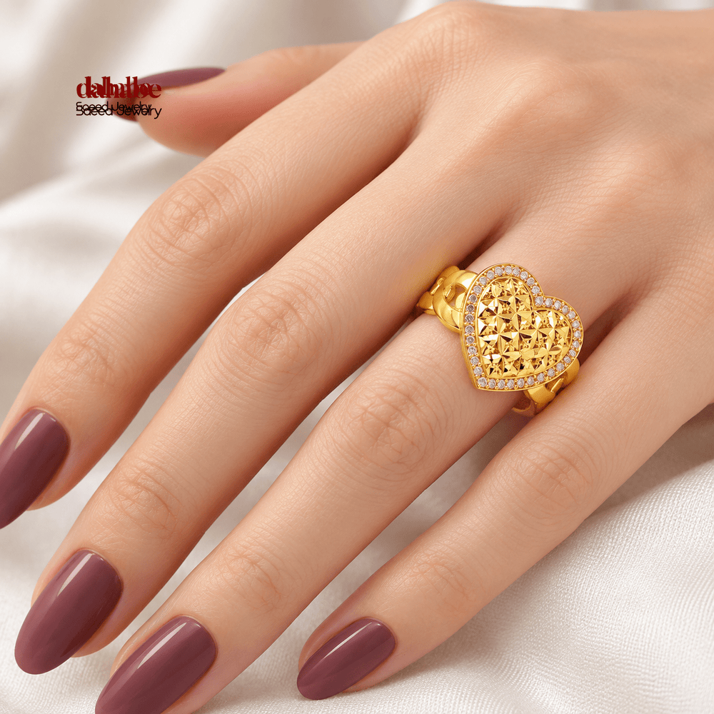 AI-generated try-on simulation of a 21K gold heart halo ring with lattice detail and clear accent stones, shown on a hand; US size 7.