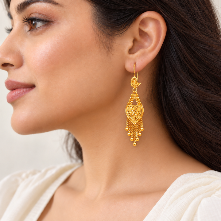 AI-generated try-on of a 21K gold Indian chandelier earring with triangular filigree and chain fringe, 5 cm