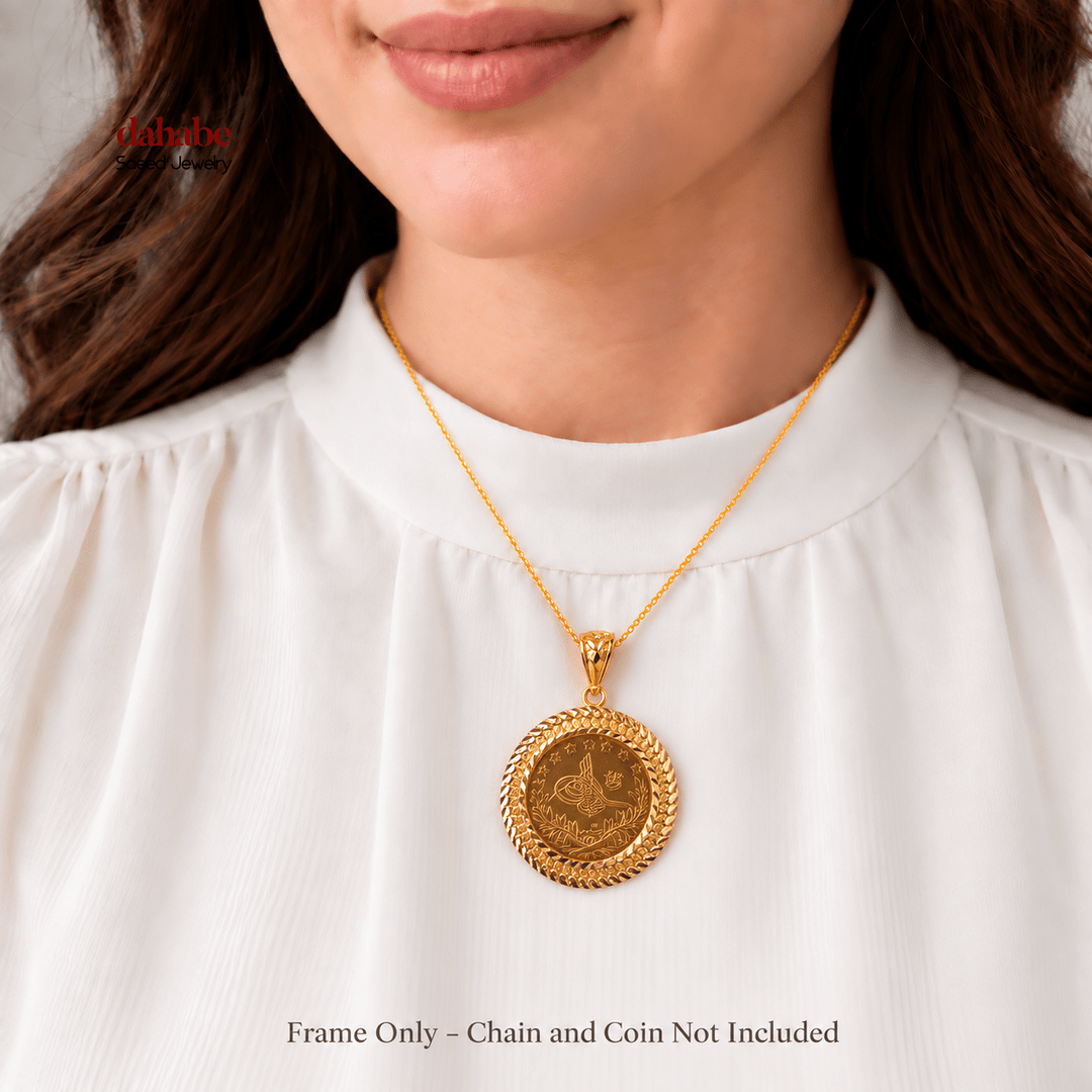 AI-generated try-on image of a 21K gold Rashadi frame pendant displayed with an Ottoman coin for scale; frame only, coin and chain not included.